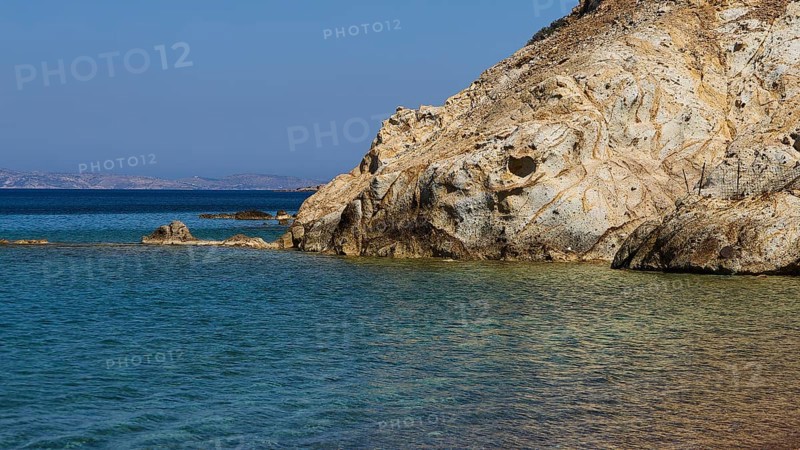 Rocky coast with calm, clear water under a blue sky, Lambi Beach, Lambi Bay, Patmos, Dodecanese, Greek Islands, Greece