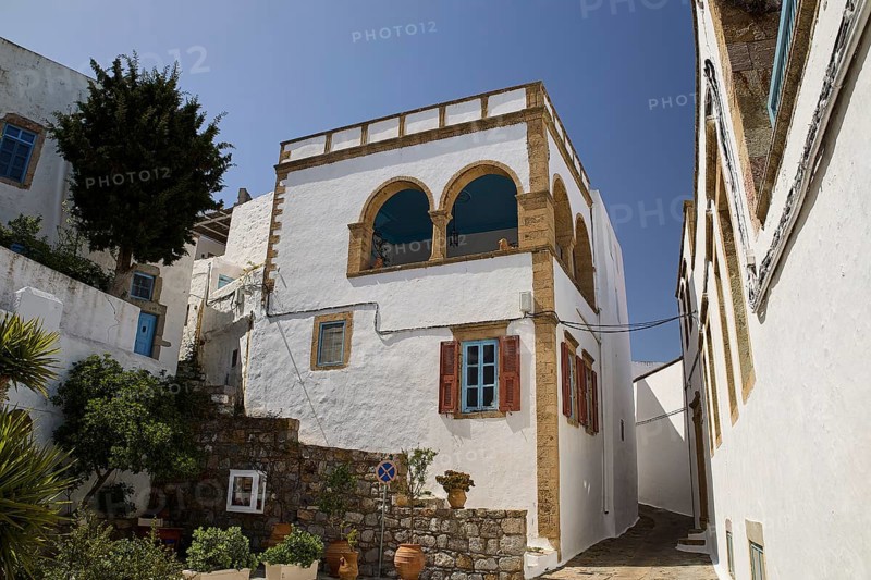 White house with striking balcony and brick details under a clear blue sky, Lion's Alley, Captain's House, Chora, UNESCO World Heritage Site 1999, Patmos, Dodecanese, Greek Islands, Greece