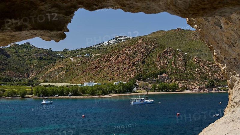 View from a cave to a coastal settlement with boats on the sea, Chora, Grikos, Rock of Kalikatsou, Patmos, Dodecanese, Greek Islands, Greece