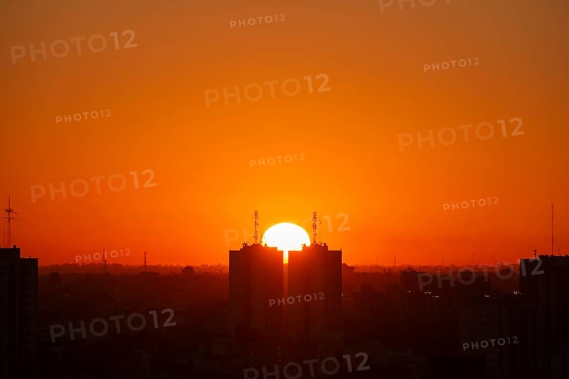 Sunset over skyscrapers in Buenos Aires, symmetry in photography, symbolic image for heat, global warming, climate change, environmental problems, Buenos Aires, Argentina