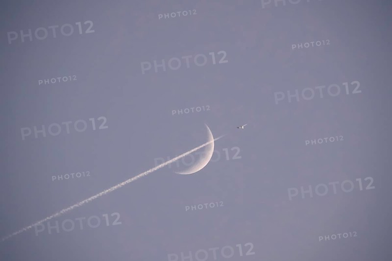 Evening sky with crescent moon and aeroplane, Germany