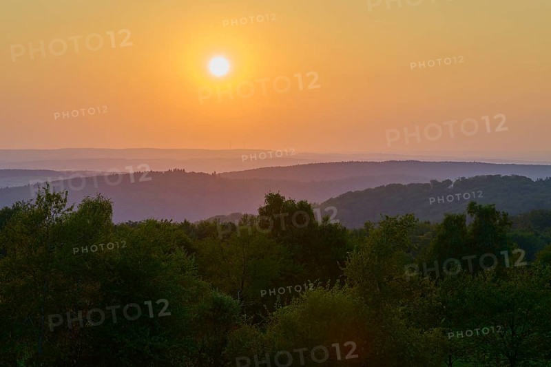 Sunset over wooded hills with orange-coloured sky, peaceful evening mood, Geishöhe, Dammbach, Spessart, Bavaria, Germany