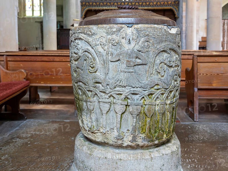 Historic baptismal font inside village parish church of Saint James, Avebury, Wiltshire, England, UK