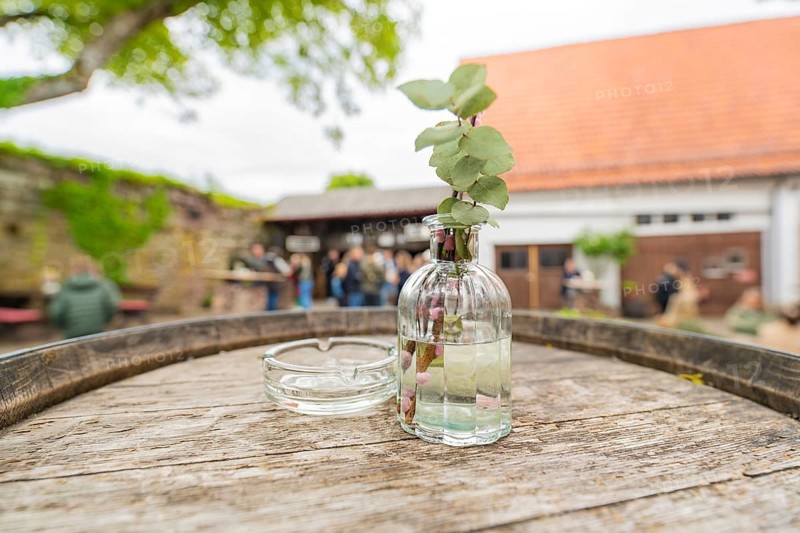 Wooden table with decorative glass bottle in a relaxed outdoor area at an event, family celebration in Neubulach, district of Calw, Germany