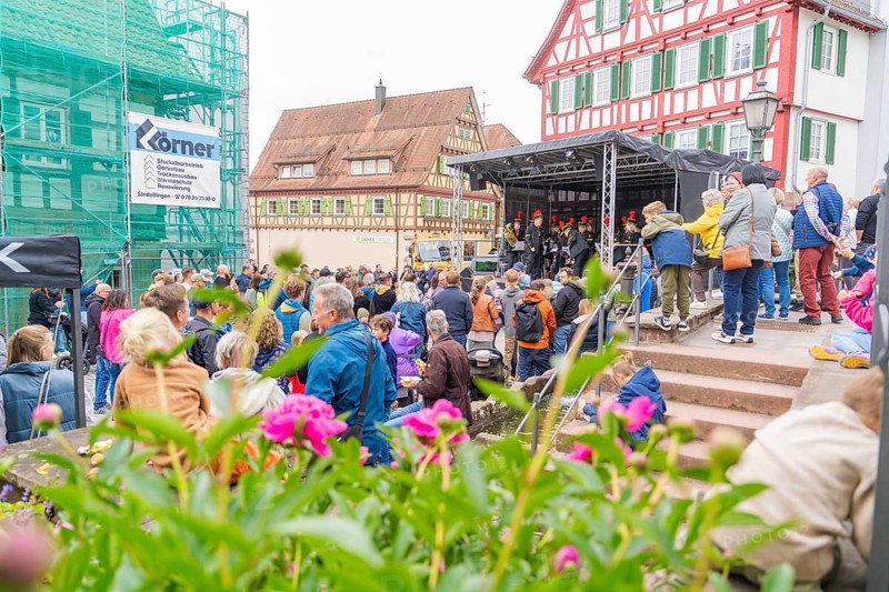 Colourful street festival with lots of people, stage and traditional houses, family festival in Neubulach, district of Calw, Germany