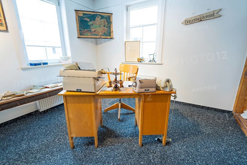 Historic office with old typewriters and telephones in a bright room, family party in Neubulach, district of Calw, Germany