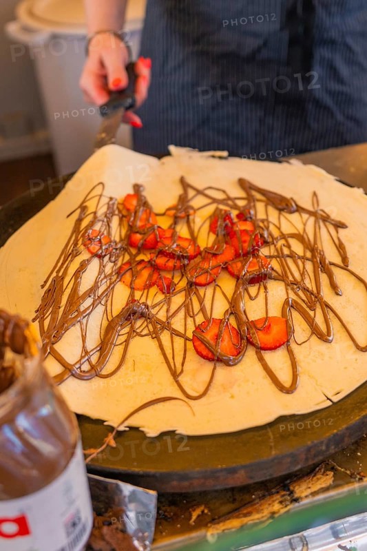 Crêpe with chocolate and strawberries being prepared on a hotplate, Calw railway station festival, Black Forest, Germany