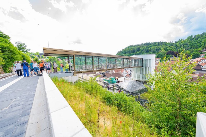 A group of people gather on a bridge overlooking a town, Zob extension with bridge construction for the new Herman Hesse railway, Calw, Black Forest, Germany