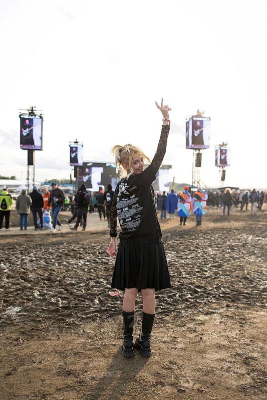 A festival visitor from Turkey poses in front of a muddy area in the evening sun at the Rock am Ring Festival on Sunday, Nürburgring race track race track, 08.06.2025