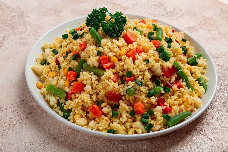 Couscous with vegetables, paprika, carrots, string beans, corn, homemade, top view, no people