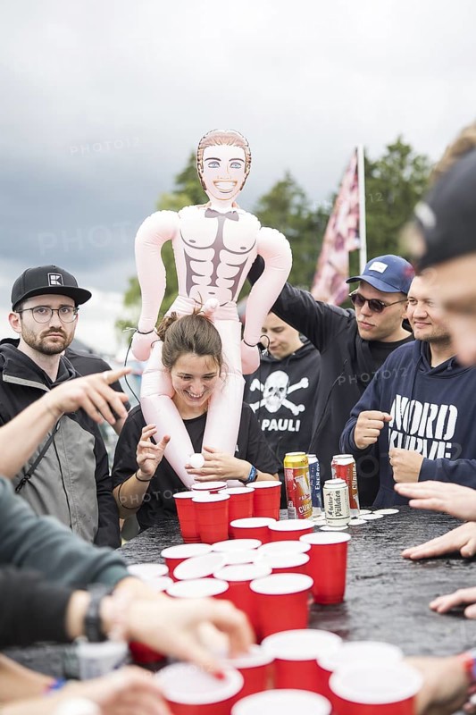 Festival visitors play a drinking game on a campsite at the Rock am Ring Festival on Saturday, Nürburgring race track race track, 07.06.2025