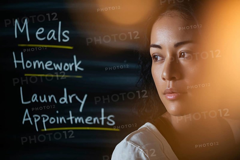 Thoughtful woman in warm light with task-filled blackboard. Concept of mental load, emotional labor, and invisible domestic responsibilities. Generative AI, AI generated