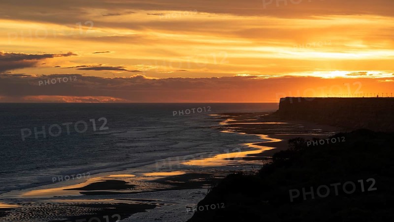 Sunset on the Atlantic coast of Patagonia at Balneario El Condor with the largest parrot colony in the world, Rio Negro province, Argentina