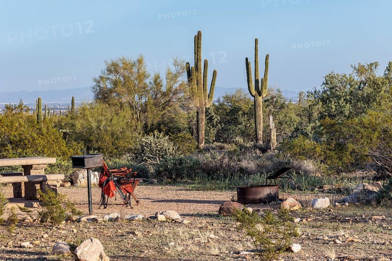 Camping chairs at a desert campsite at the White Tank Mountain Regional Park campground in Phoenix, Arizona, USA