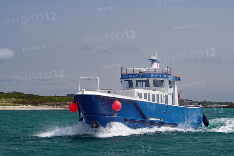 Large blue boat in motion on wavy sea with red buoy, passenger ferry, Isles of Scilly, Cornwall, England, Great Britain
