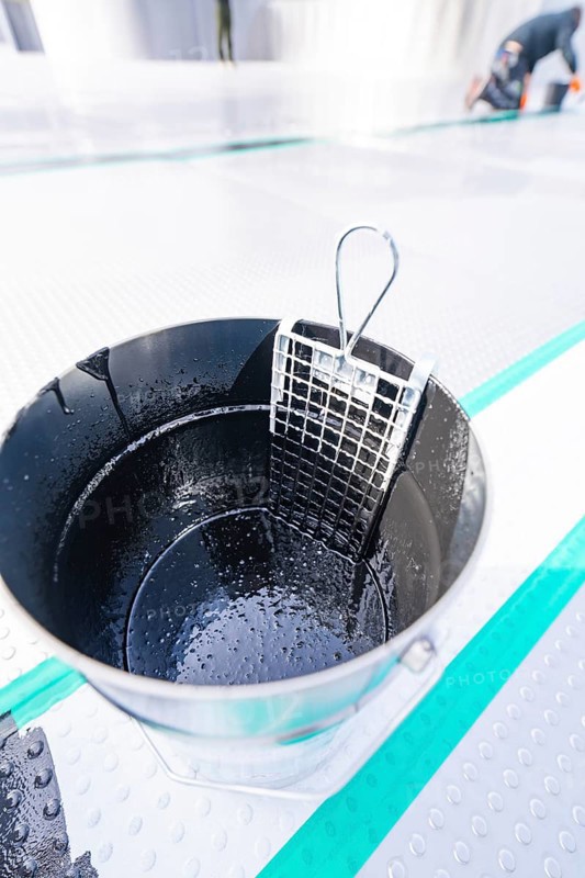 Close-up of a wet metal bucket with grid insert, shiny and detailed, renewal of the swimming lines, Calw Stammheim outdoor pool, Calw, Black Forest, Germany