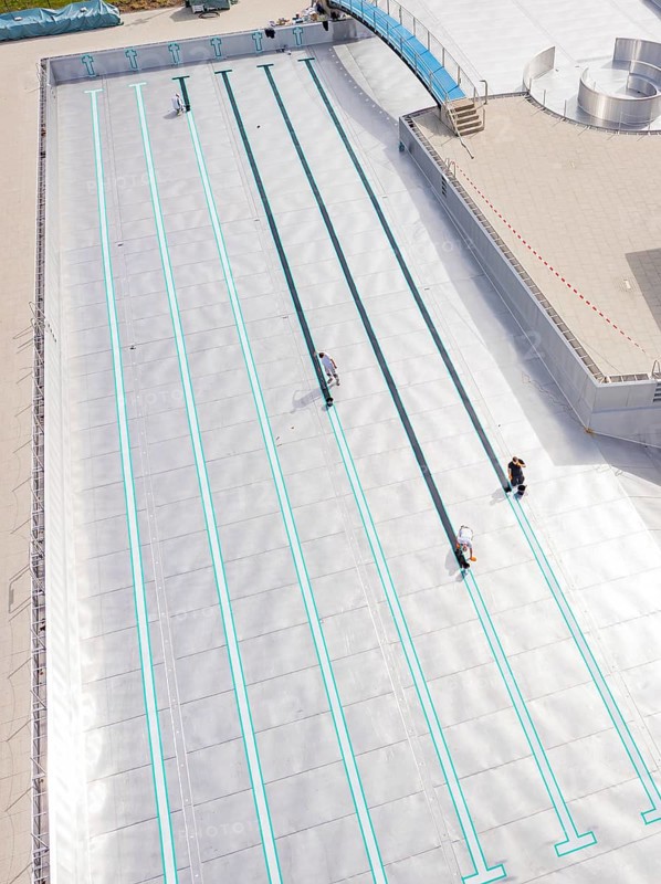 Close-up of the swimming lanes with three people in the empty pool area, renovation of the swimming lines, Calw Stammheim outdoor pool, Calw, Black Forest, Germany