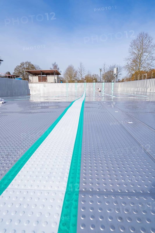 View along an empty swimming pool with striking stripes in the sun, renewal of the swimming lines, Calw Stammheim outdoor pool, Calw, Black Forest, Germany