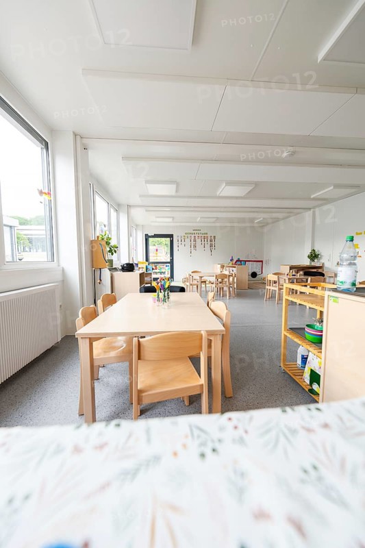 Bright kindergarten room with wooden furniture and large windows, transitional containerised daycare centre, Gechingen daycare centre, Calw district, Germany