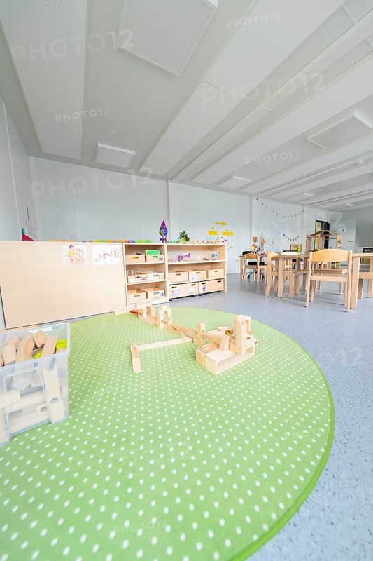 Kindergarten with green carpet and building blocks on the floor, transitional containerised daycare centre, Gechingen daycare centre, Calw district, Germany