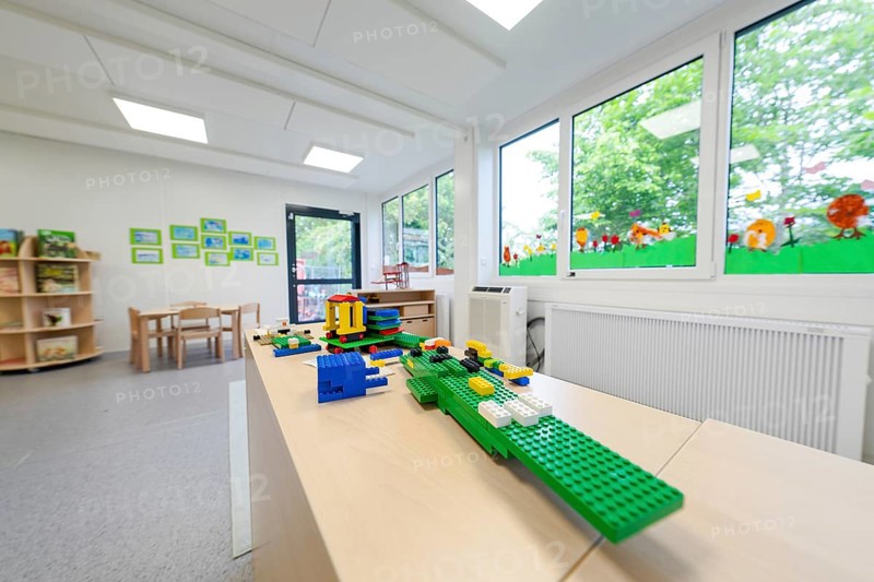 Kindergarten room with building blocks on a table, large windows with a view of the countryside, transitional daycare centre in container construction, Gechingen daycare centre, Calw district, Germany