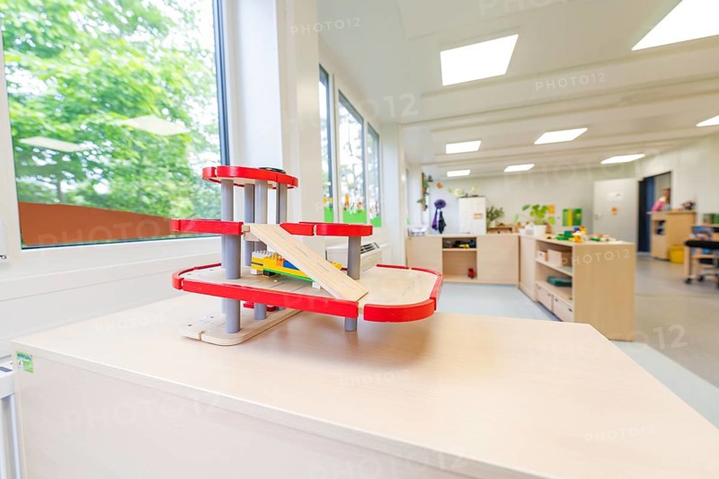 Kindergarten room with a red race track for toy cars and large windows, transitional containerised daycare centre, Gechingen daycare centre, Calw district, Germany