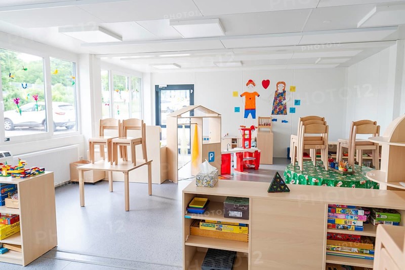 Bright room with toys, set-up chairs and shelves in the foreground, transitional daycare centre in container construction, Gechingen daycare centre, Calw district, Germany