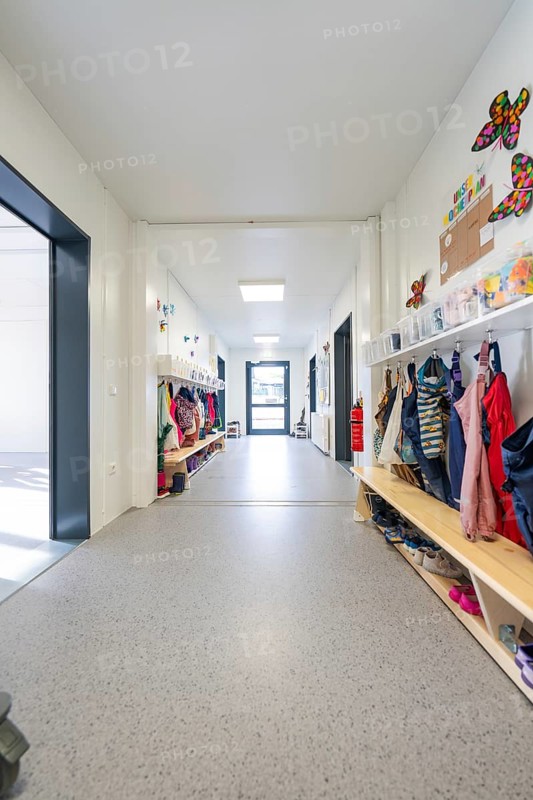 Bright corridor in a kindergarten full of children's clothes and colourful decorations, transitional daycare centre in container construction, Gechingen daycare centre, Calw district, Germany