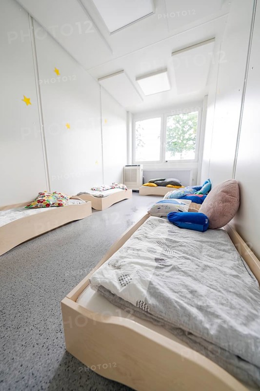 Light-flooded dormitory with low beds and pillows under the stars, transitional daycare centre in container construction, Gechingen daycare centre, Calw district, Germany