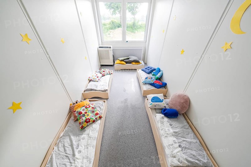 Relaxation room with small beds, soft blankets and decorative elements on the walls, transitional daycare centre in container construction, Gechingen daycare centre, Calw district, Germany