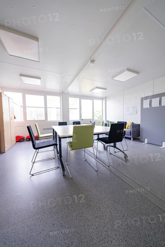 Bright meeting room with various chairs and table in a modern style, transitional daycare centre in container construction, Gechingen daycare centre, Calw district, Germany