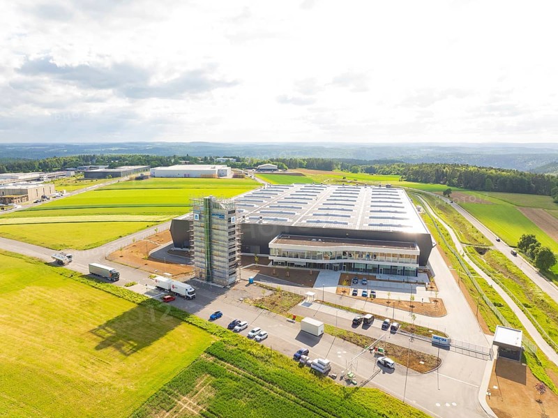 Large industrial facility in a rural setting with vehicles and wide fields, ING Park development area, Zweckverband INGpark Nagold Gäu, Nagold, Germany
