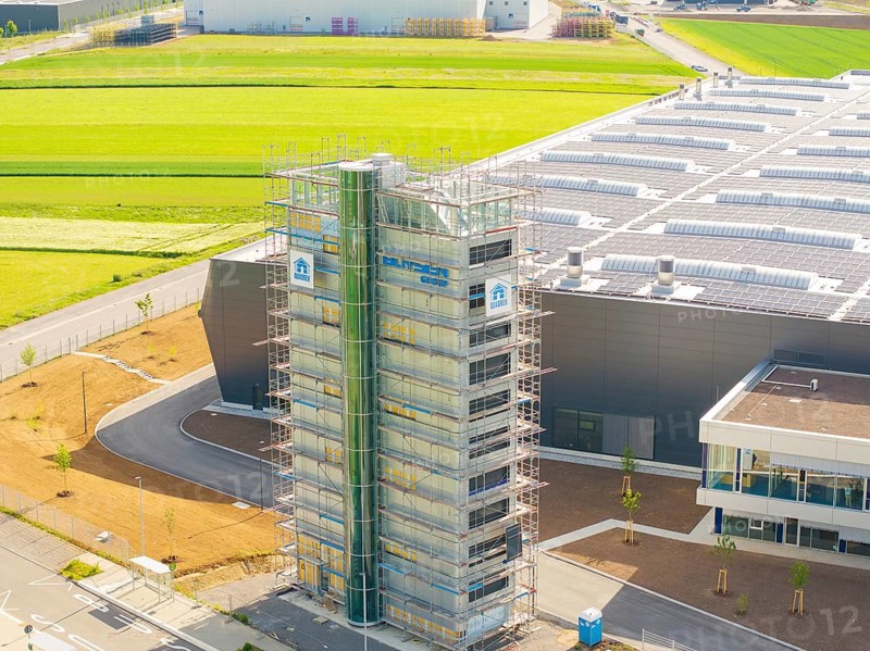 Industrial building with scaffolding and solar panels, surrounded by green fields, ING Park development area, Zweckverband INGpark Nagold Gäu, Nagold, Germany