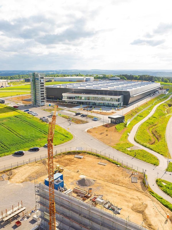 Large industrial building under construction with crane in rural surroundings, ING Park development area, Zweckverband INGpark Nagold Gäu, Nagold, Germany