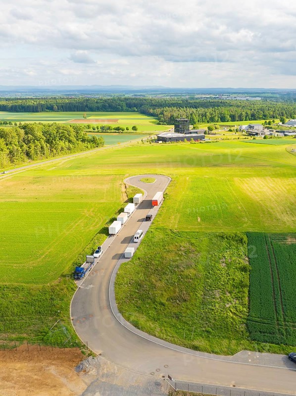 Country road with parked vehicles and extensive fields in a rural setting, ING Park development area, Zweckverband INGpark Nagold Gäu, Nagold, Germany
