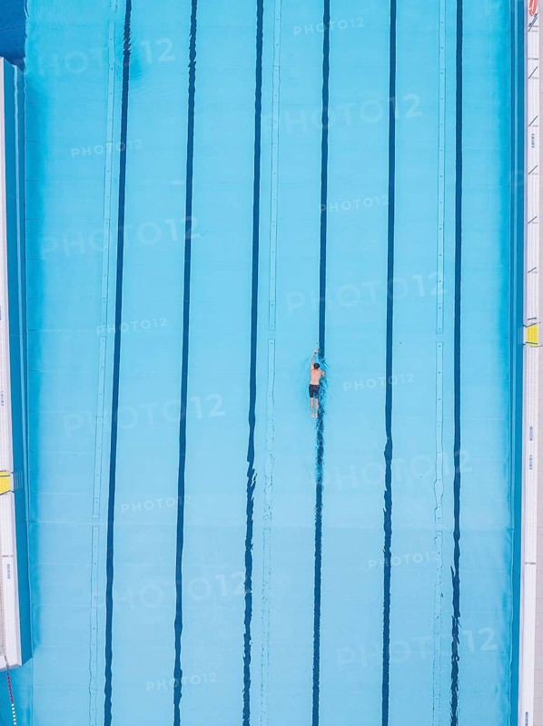 A lone swimmer does his laps in an empty pool, Calw outdoor pool, Black Forest, Germany