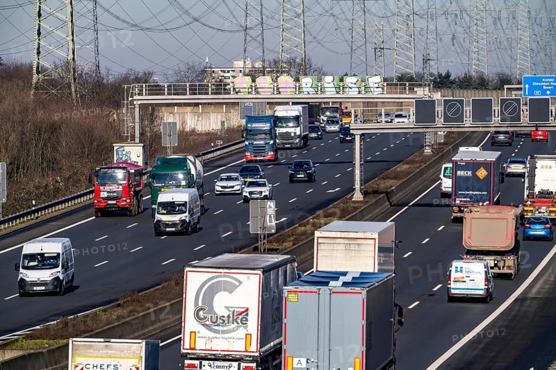 A57 motorway near Kaarst in the Rhein-Kreis Neuss, view towards Kaarst motorway junction, heavy traffic, overhead line, high-voltage lines, along the motorway, North Rhine-Westphalia, Germany