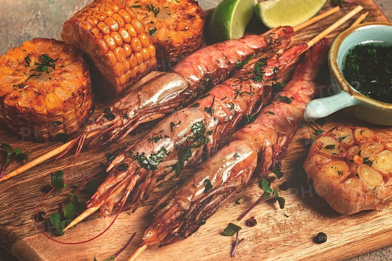 Langoustines on skewers, shrimp kebab, with fried corn, spices and herbs, homemade, no people