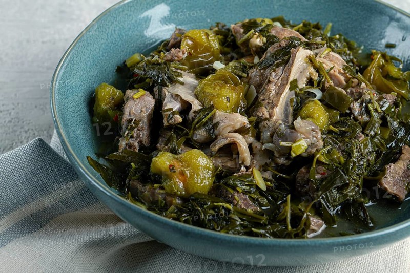 Chakapuli, Georgian dish, stewed meat with herbs and tkemali, in white wine, homemade, no people