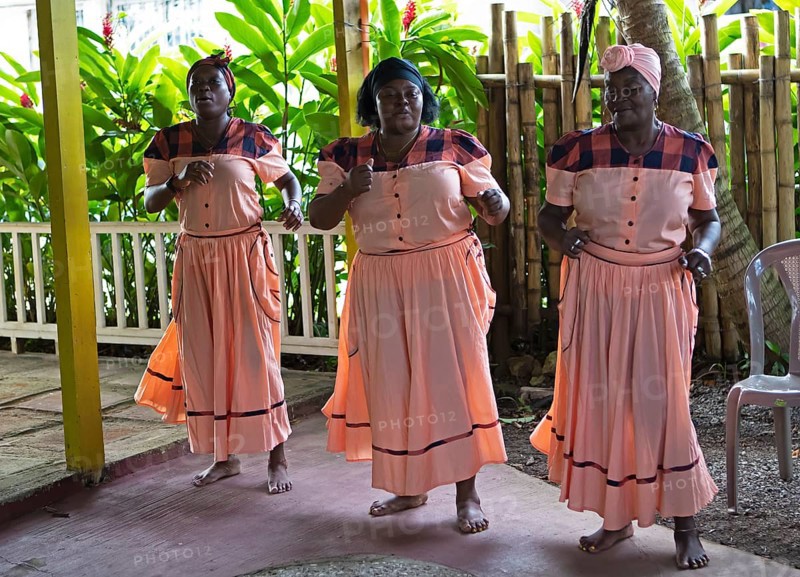Guatemalan woman in traditional clothing singing and dancing, Garifuna people, Livingston, Izabal Department, Guatemala