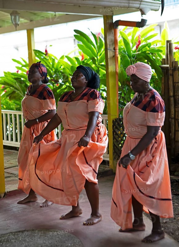Guatemalan woman in traditional clothing singing and dancing, Garifuna people, Livingston, Izabal Department, Guatemala