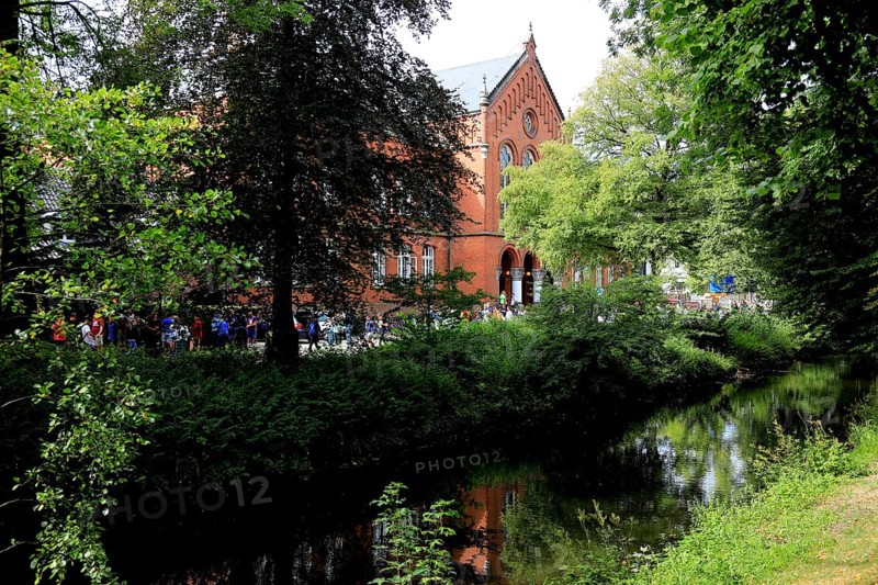 The Old Gymnasium Oldenburg was built in the style of round arch historicism based on designs by architect Heinrich Strack the Elder. The hair flows in the foreground of the photo, Lower Saxony, Germany