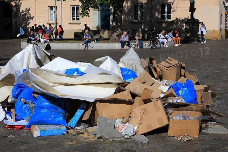 A pile of waste paper and cardboard on the street, remnants of an event, trash, trash, here in Oldenburg, Lower Saxony, Germany