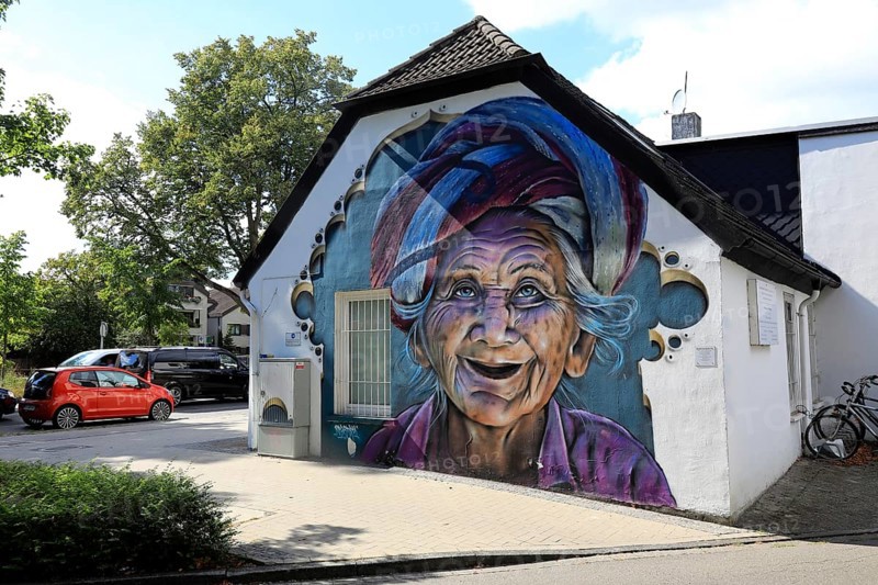 Graffiti portrait of an elderly woman from Bali. The work of art is part of the Kultur aus Tausch project. The aim of this initiative is to bring portraits of different cultures around the world to the streets of Oldenburg, Lower Saxony, Germany