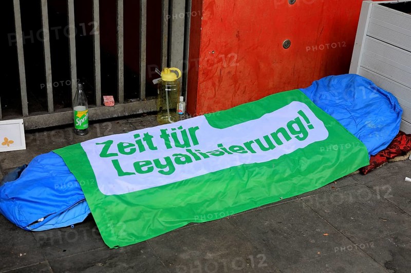 Sleeping bag and overnight place of a homeless person, on it a foil with the inscription Time for Legalization, here in Oldenbrug, Lower Saxony, Germany