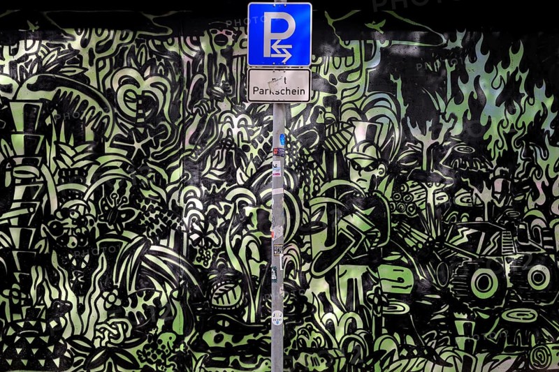 Parking sign in front of a graphite wall