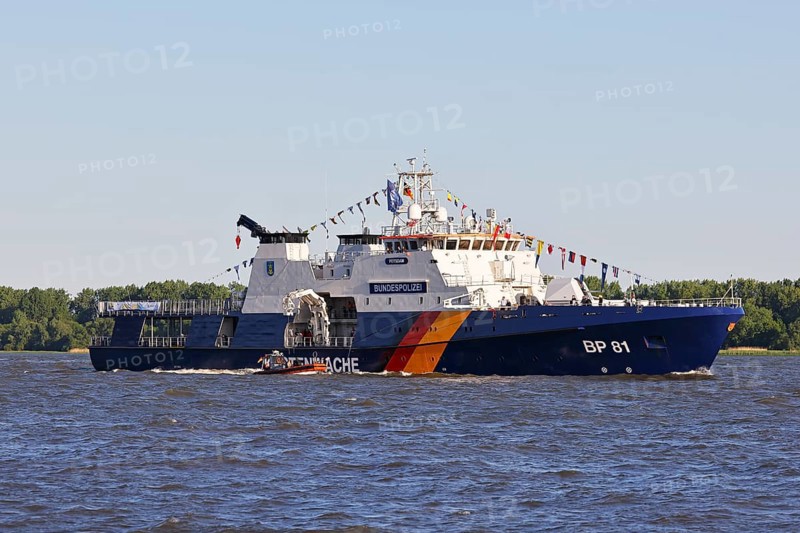 Decorated ship of the German Coast Guard and Federal Police BP 81 Potsdam leaves the Port of Hamburg on the Elbe after Hamburg's port birthday, Wedel, Schleswig-Holstein, Germany