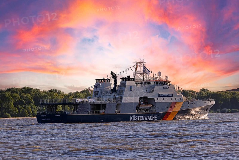 Decorated ship of the German Coast Guard and Federal Police BP 81 Potsdam leaves the Port of Hamburg on the Elbe after Hamburg's port birthday, Schleswig-Holstein, Germany