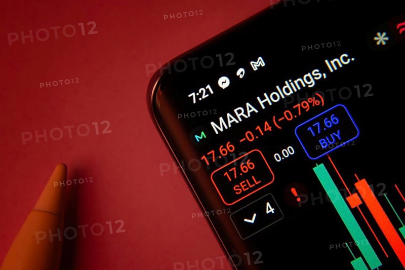Dhaka, Bangladesh- 08 Sep 2025: Close-up of a phone screen showing MARA Holdings Inc stock market data with a candlestick chart
