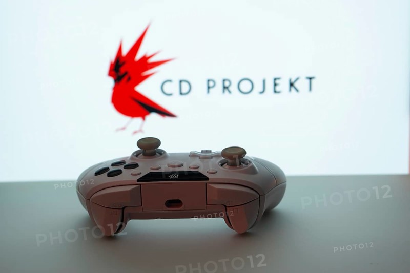 Dhaka, Bangladesh- 08 Apr 2025: A gaming controller in front of a CD Projekt screen